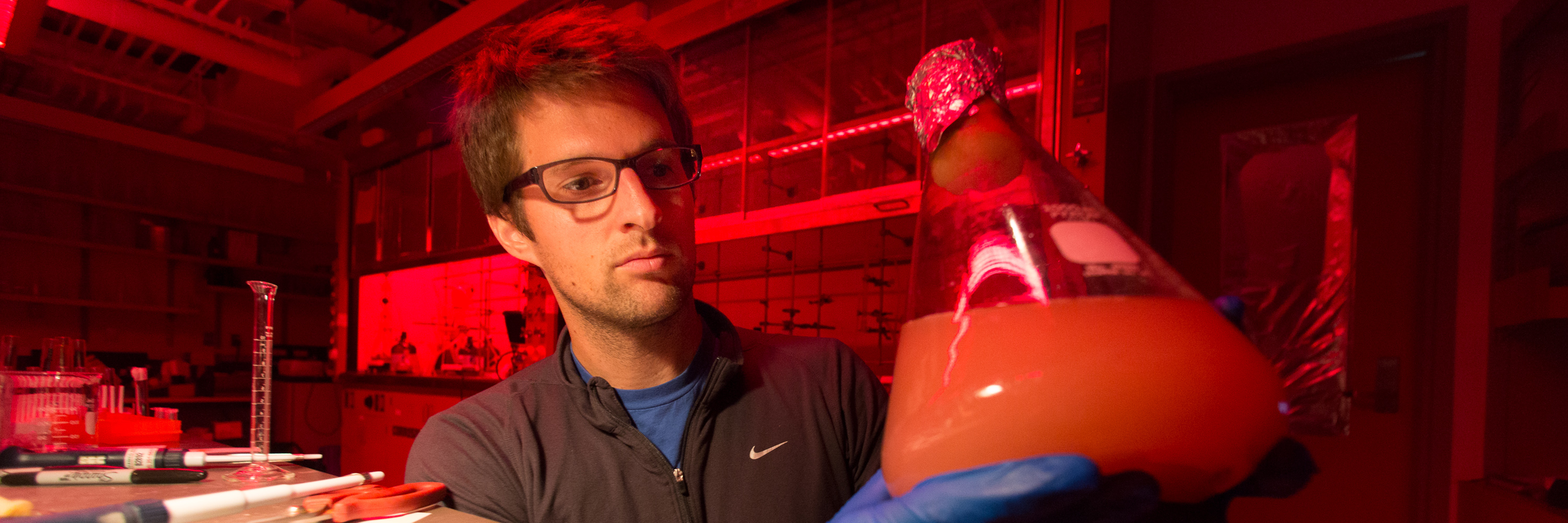 Scientist holding beaker in lab